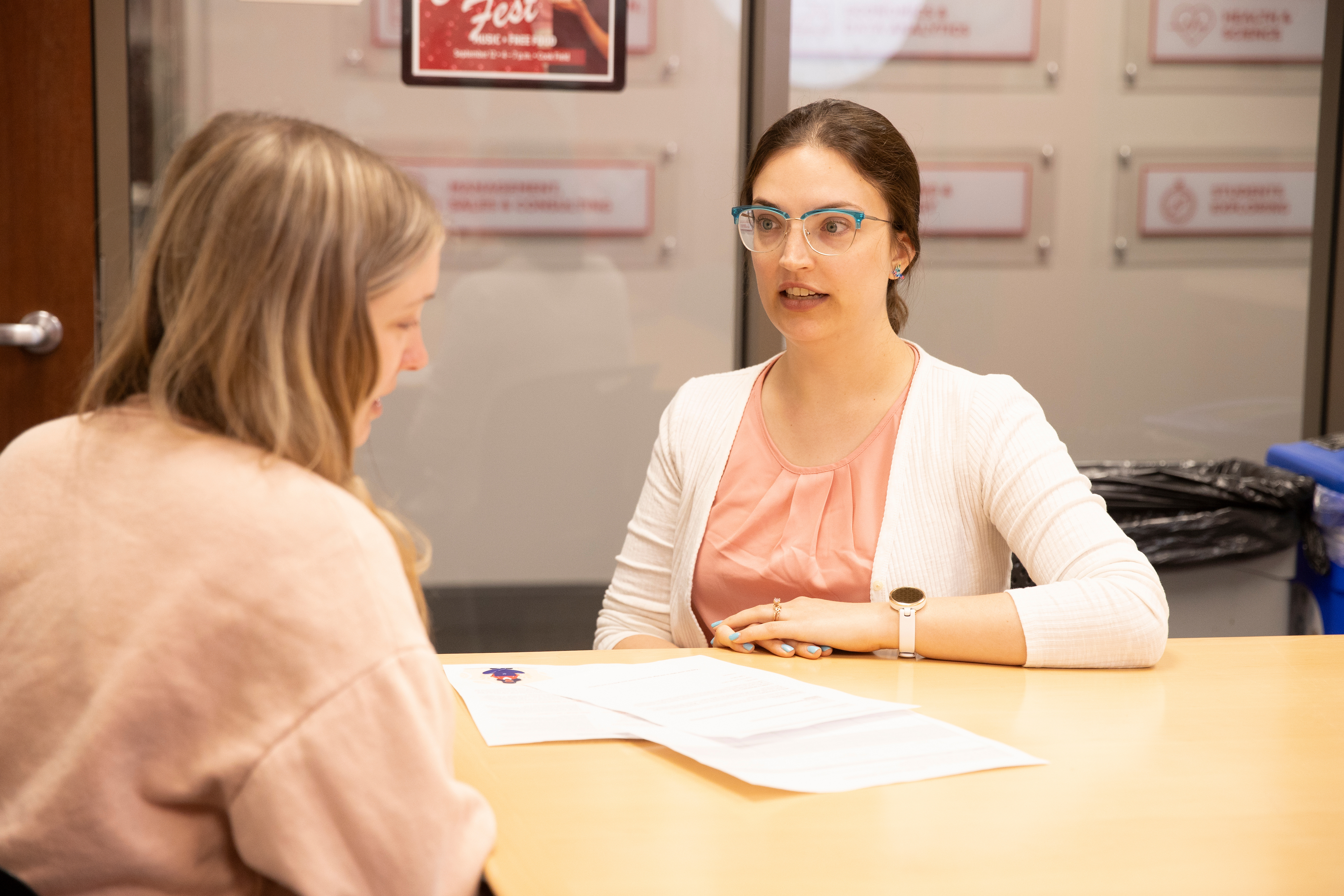 A career advisor reviews a resume and cover letter with a student.