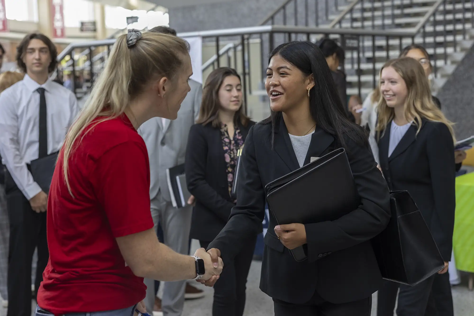 Photo of a Miami student networking with an employer at Career Fair