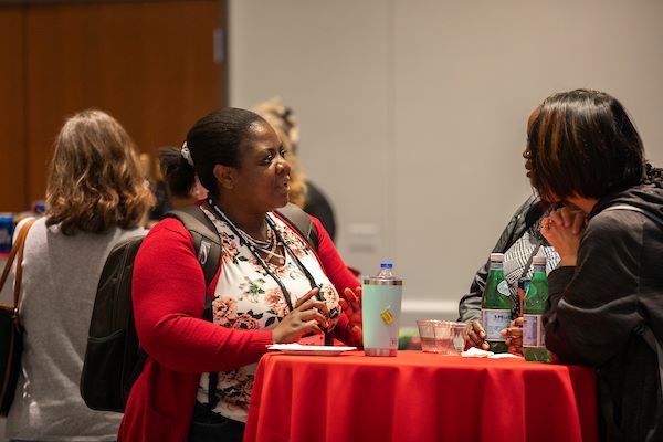 Two women talking at a networking event.