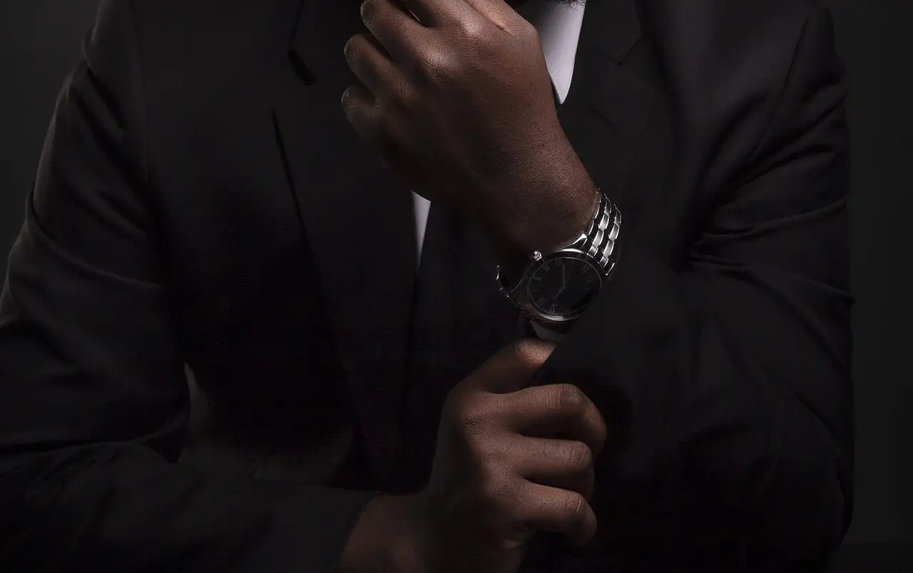image of a student adjusting his cufflinks