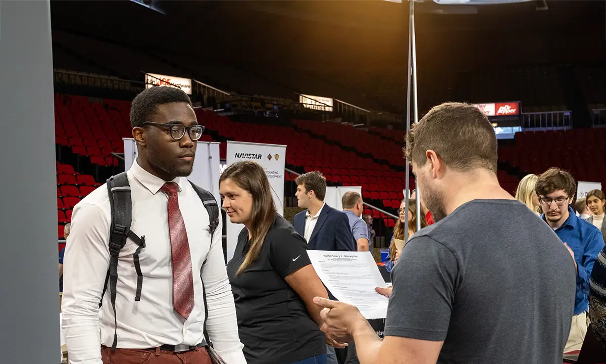 student interviewing with an employer at Career Fair