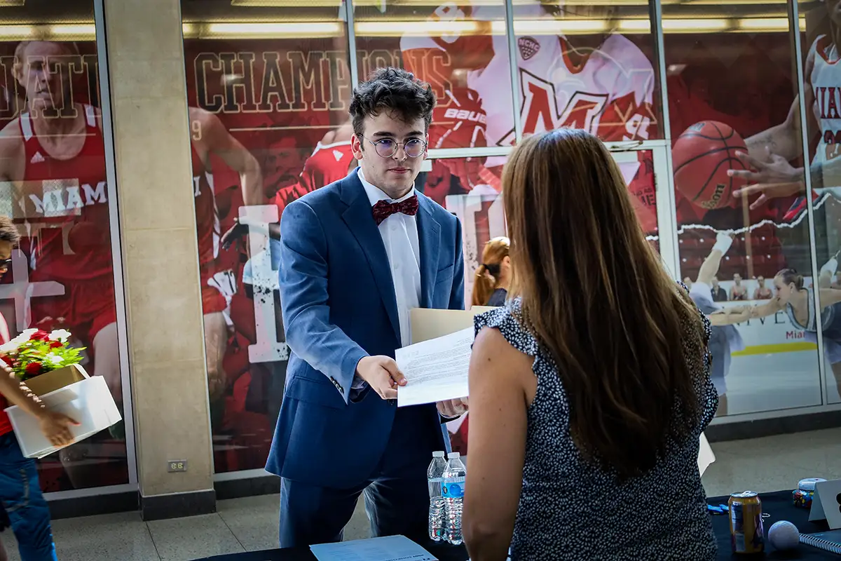 Miami student giving an employer a resume at the Career Fair