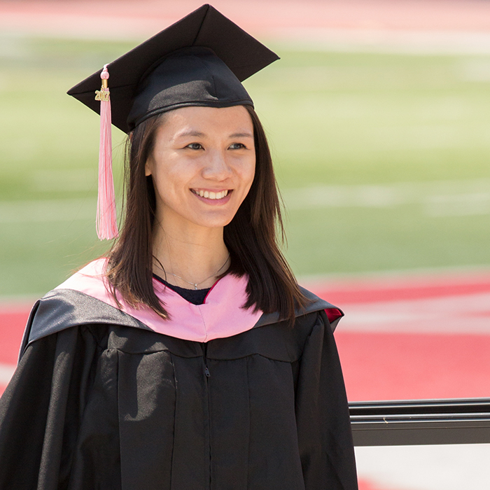 female student dressed in a cap and gown