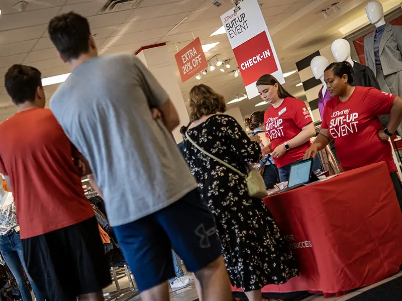 Career Center staff help students check in to Suit-Up at JCPenney