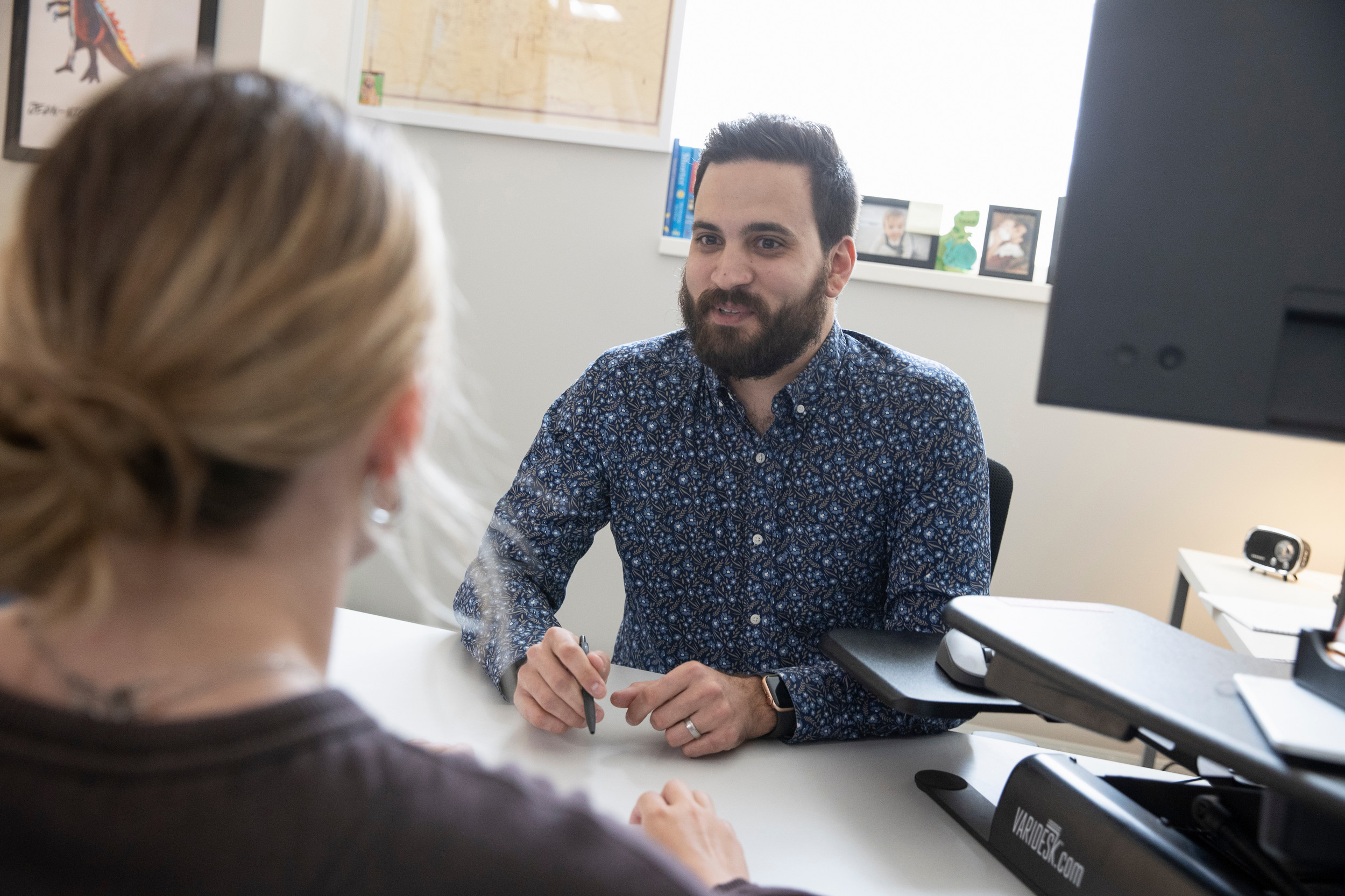 A career advisor laughs while meeting with a student.