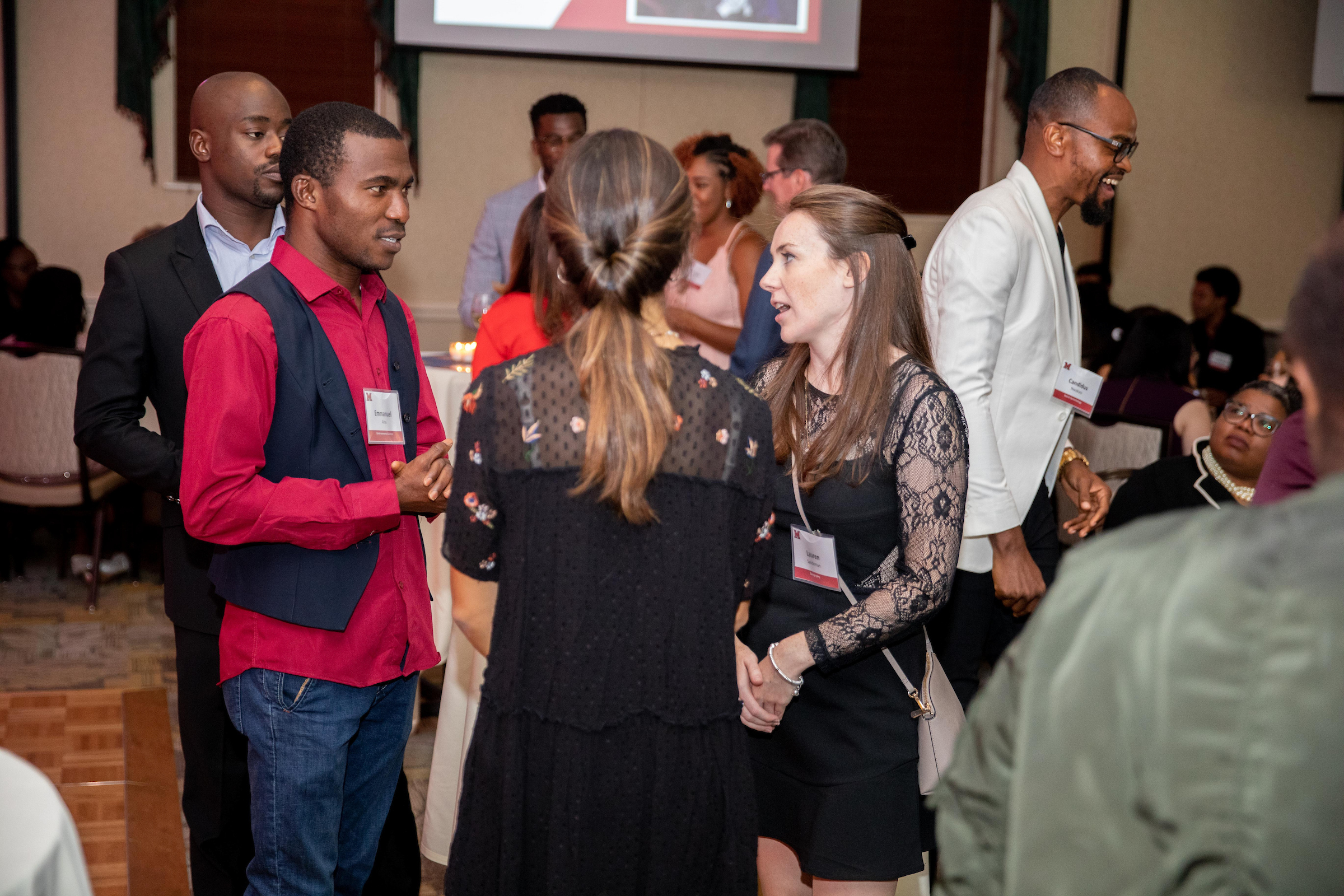 Students network at a reception.