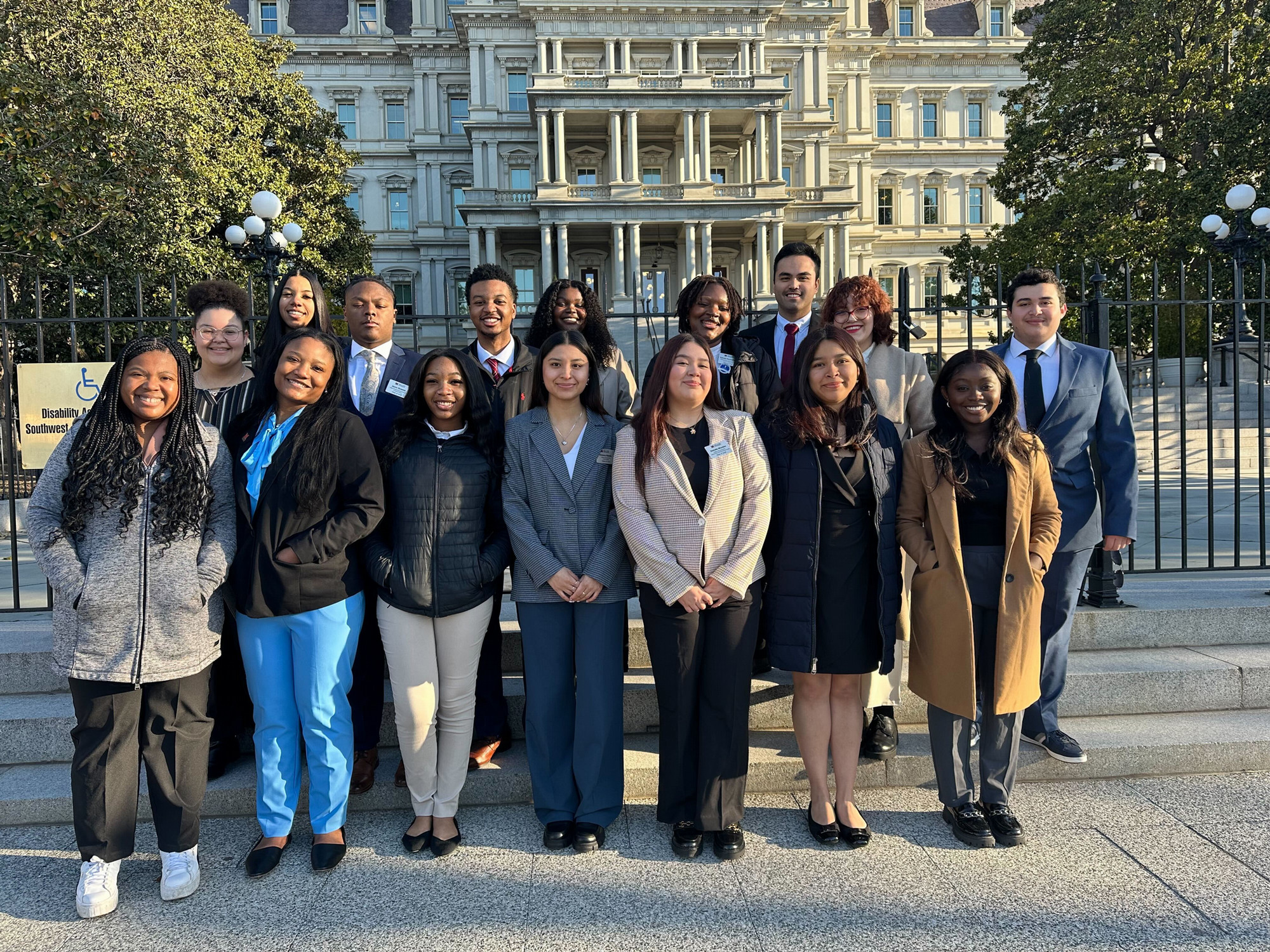 Students pose in front of a building during a Career Academy experience.