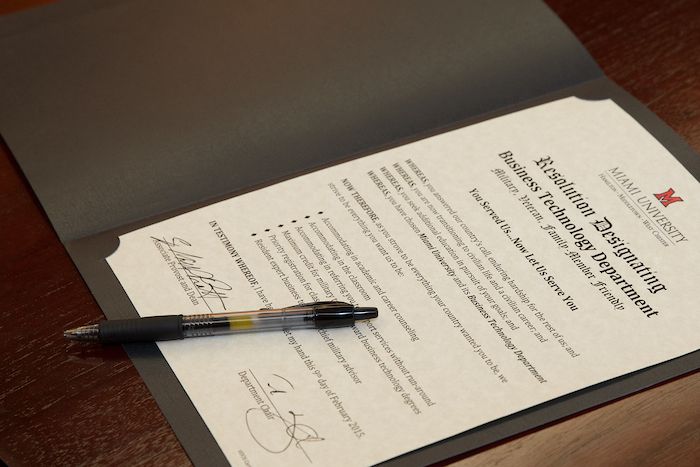 Certificate on a table with a pen.