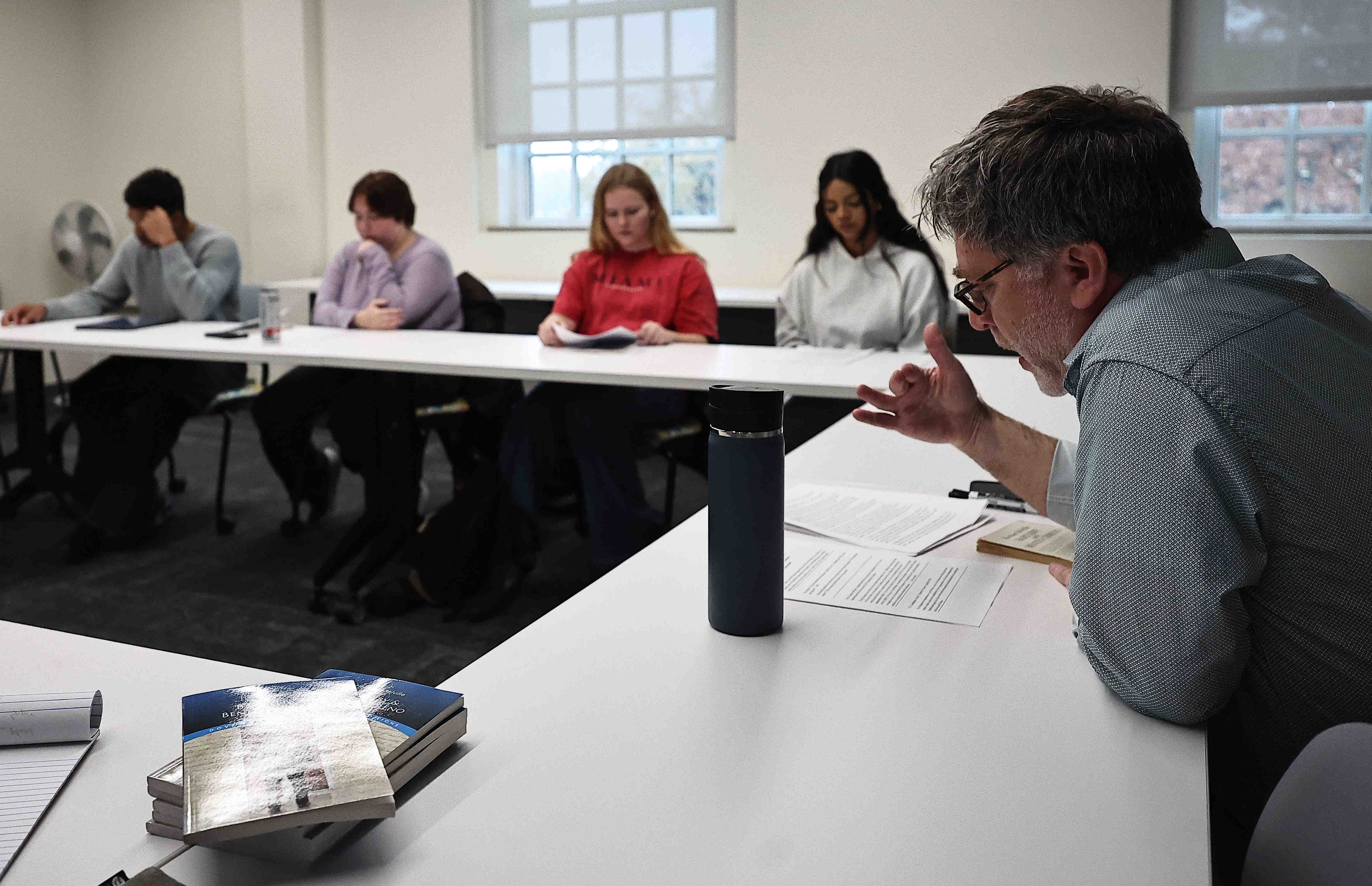Brian Danoff seated at a table speaking to students