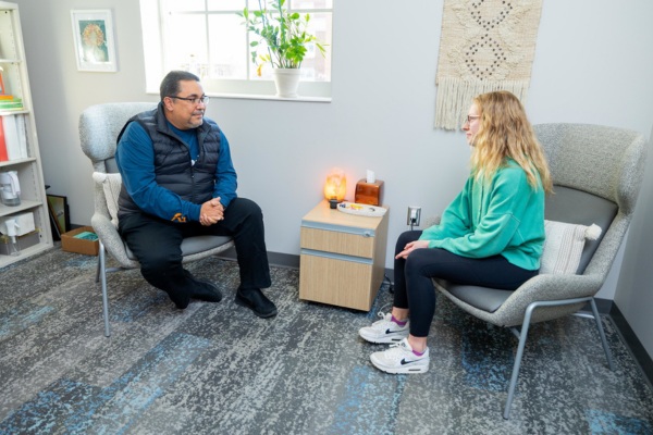 Student and counselor in a counseling office.