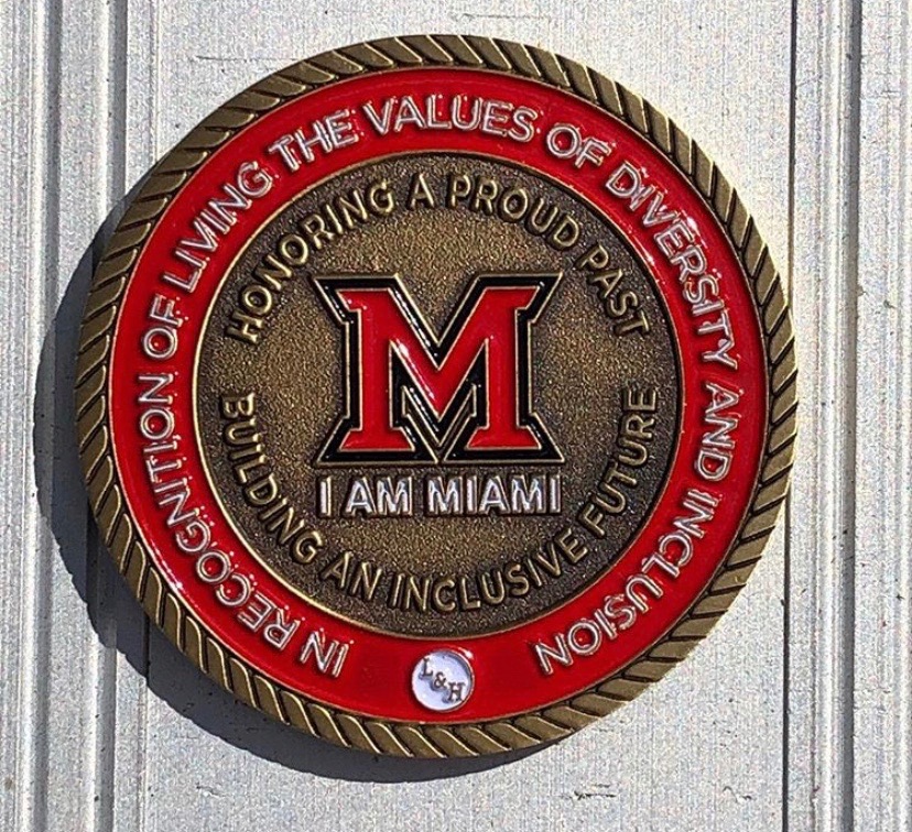 Medallion that reads in recognition of living the values of diversion and inclusion. Honoring a proud past. Building an inclusive future. I am Miami.