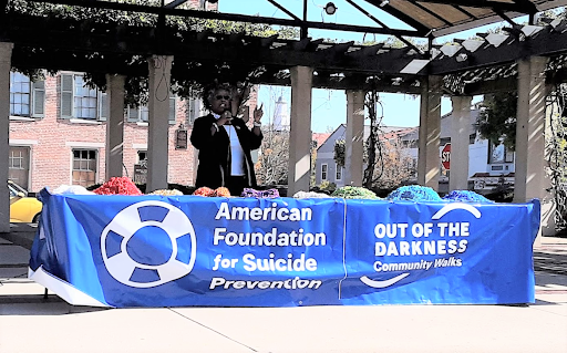 Reverend Vanessa Cummings speaking on stage at the Out of Darkness Walk