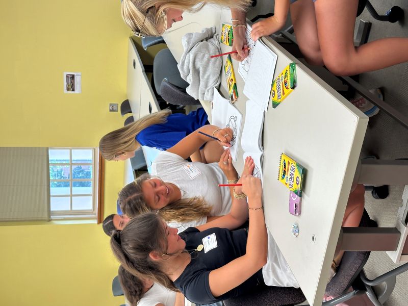 Students coloring together at orientation.