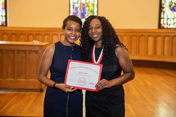 Amanda Sargent holding award at 2019 PDSA ceremony, with sister Angela. 