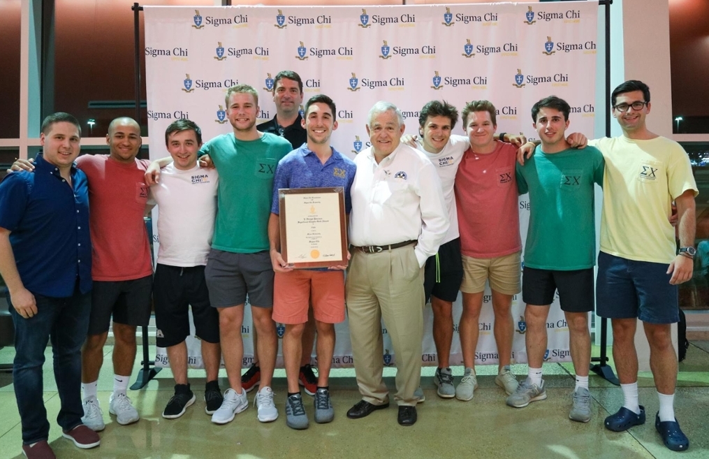 Sigma Chi Brothers holding up an award plaque