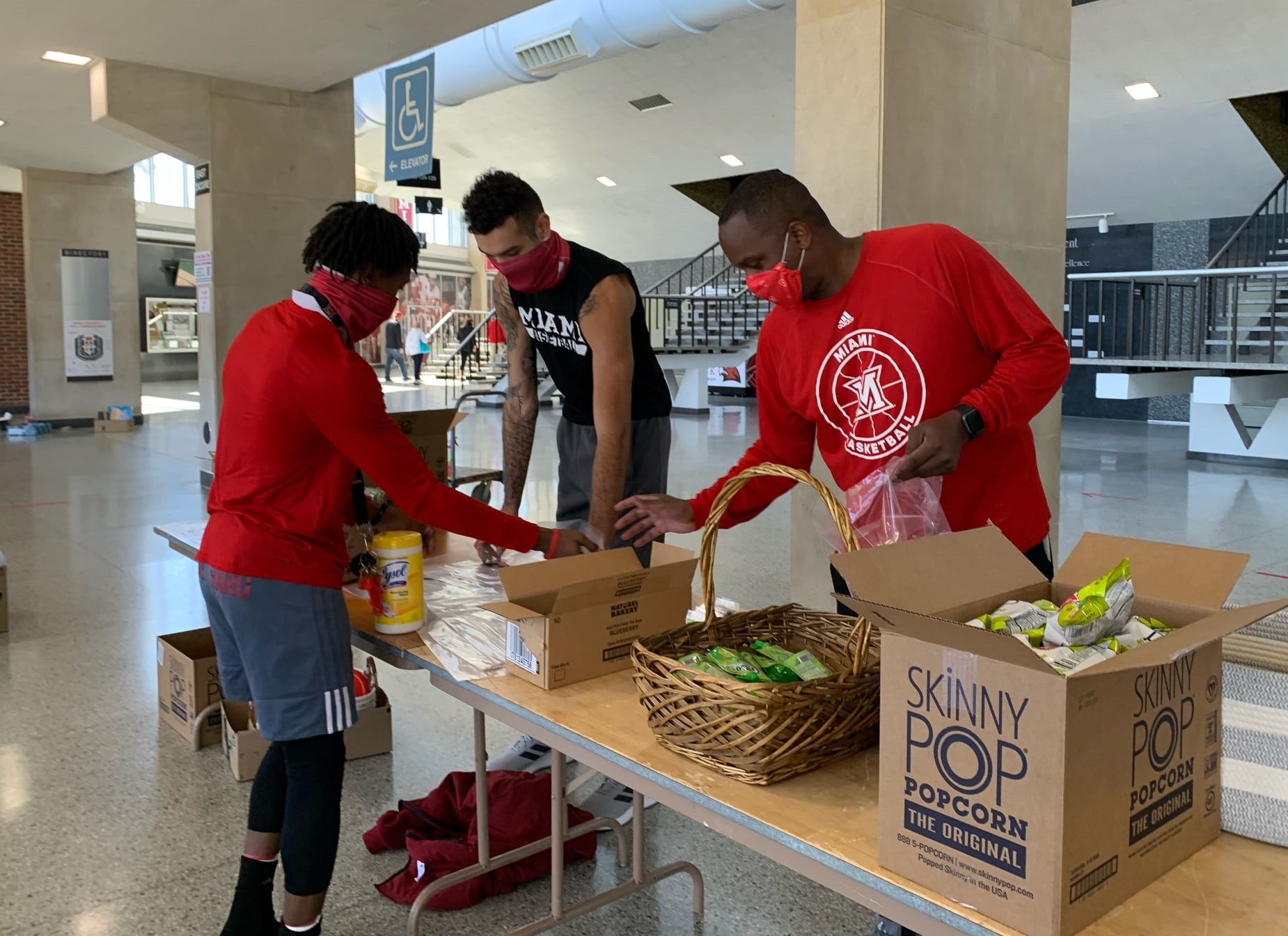 men's basketball team members assembling packages