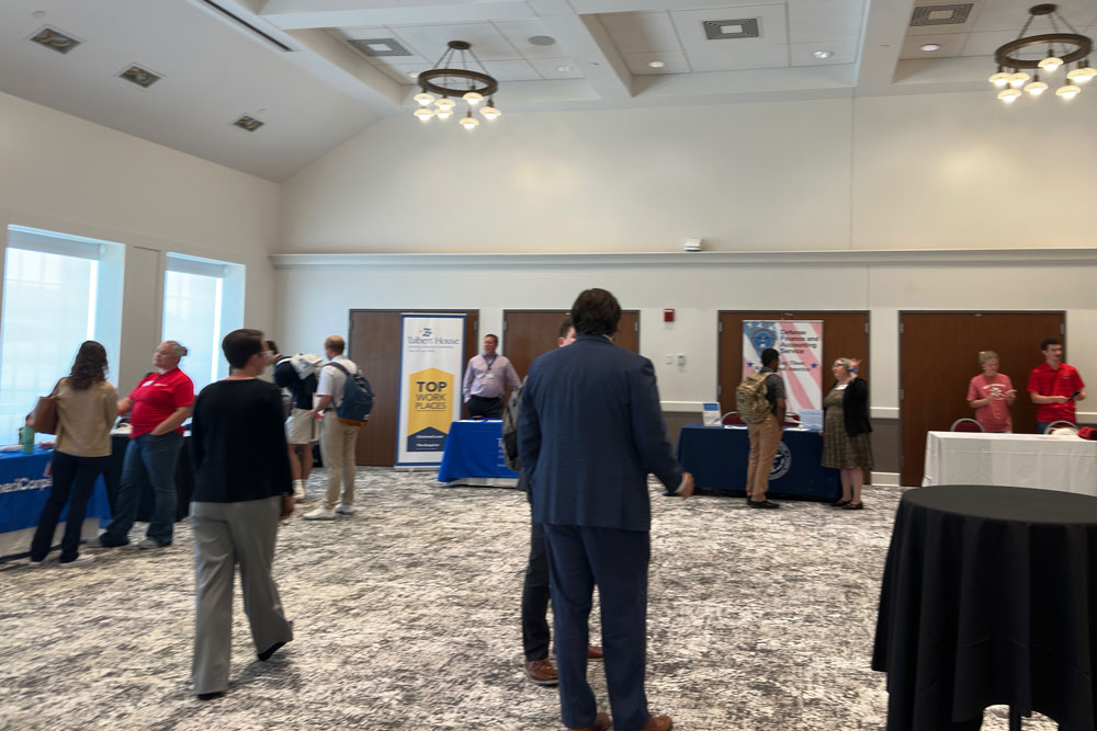 People standing at a table at the career fair