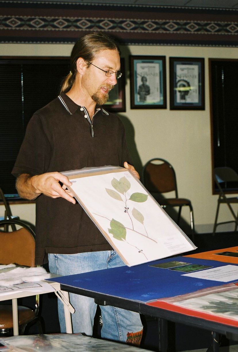 Michael Gonella presents some dried and pressed plant samples to the Miami Tribe community at a gathering in 2005