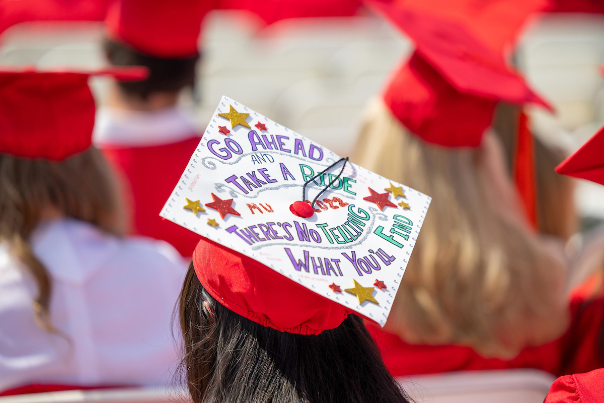 A graduation cap with "MU 2022: Go ahead and take a ride, there's no telling what you'll find" written on it.