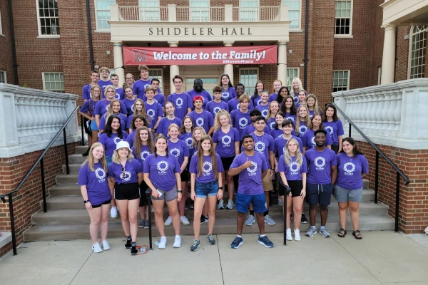 group of students in front of shideler hall with purple shirts on 