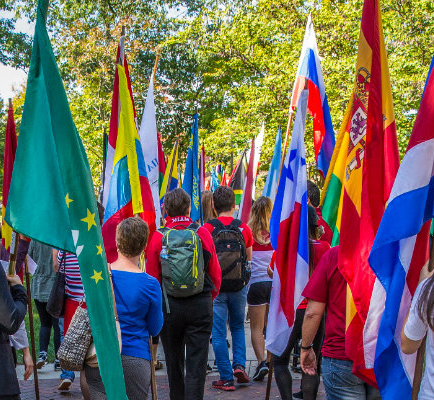 Students participating in an international flag parade