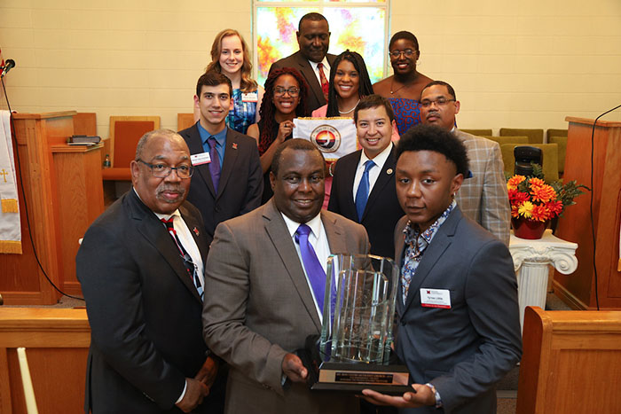 Vice President for Institutional DIversity and Inclusion, Ron Scott, posing with members of the Mt. Zion Church, holding their award