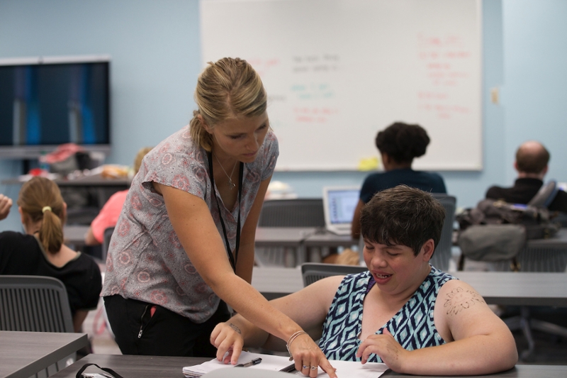 Faculty member Ashley Johnson working with a student in the new accessible classroom