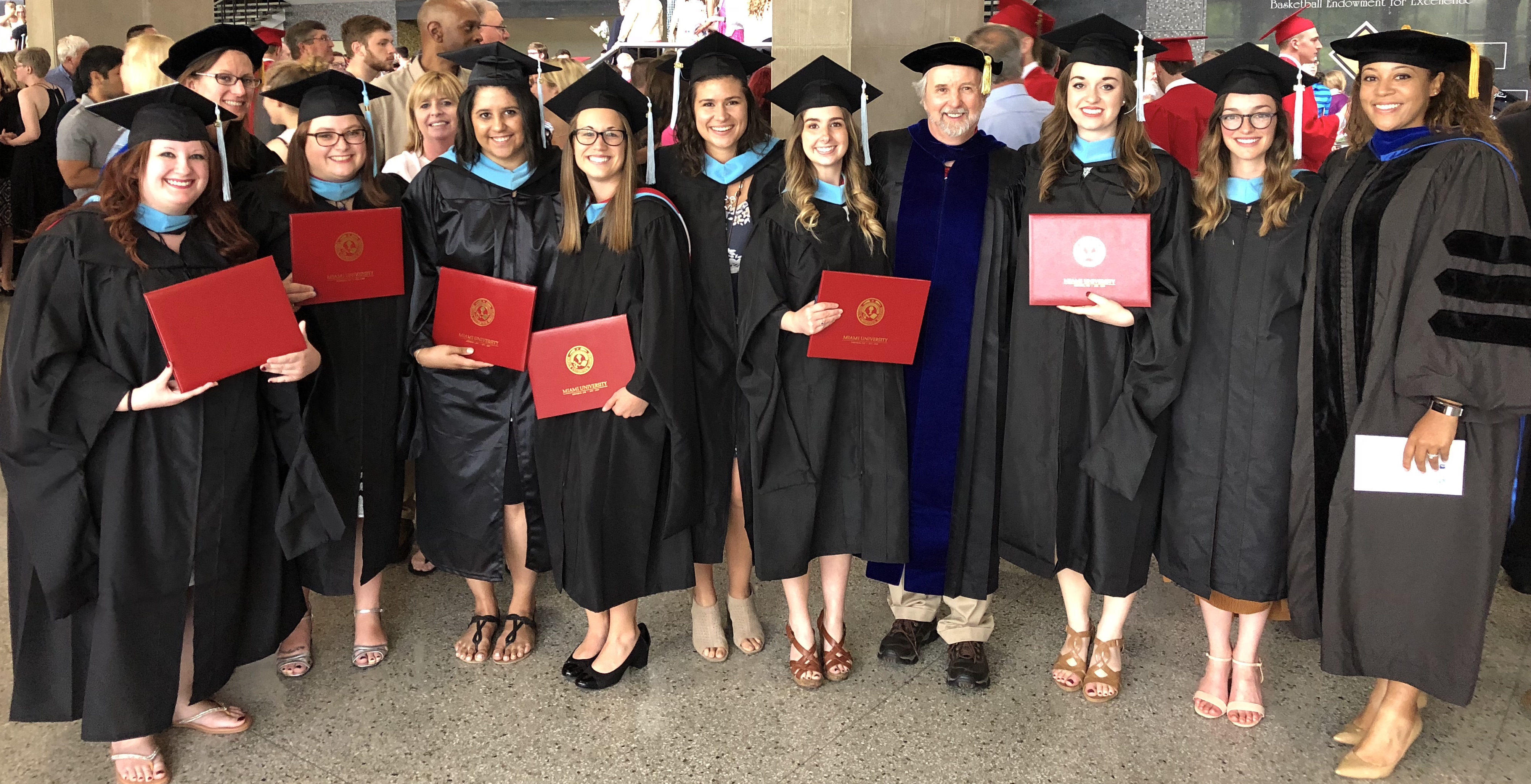school of psychology graduates pose for picture together