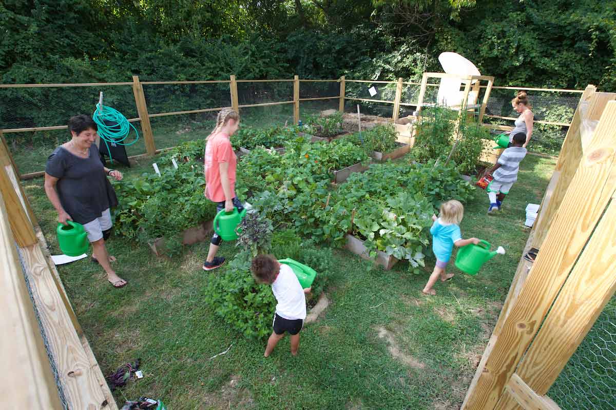 Two families tending to a section of the Oxford Community Garden.