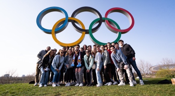 SLAM students posing under the Olympic rings in Spain