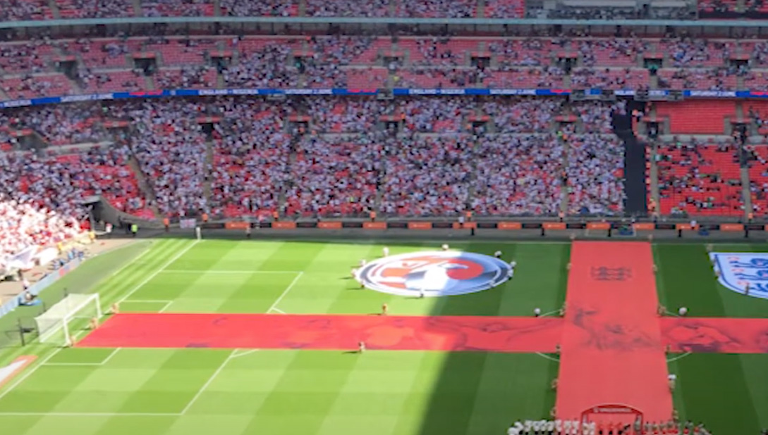 A packed football stadium during a game in London, England