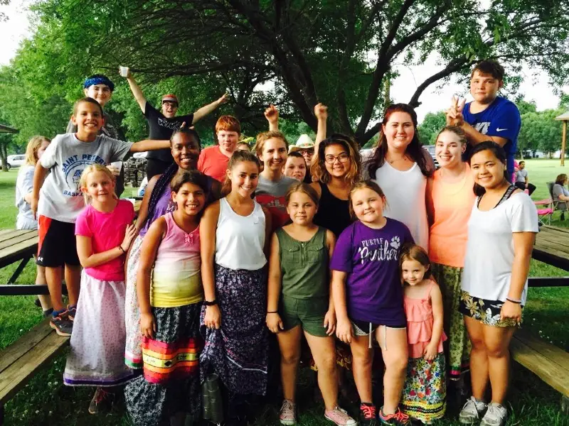 group of children with counselor at park outside