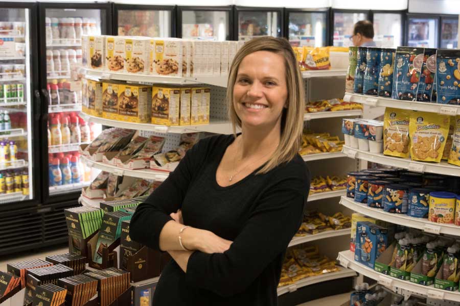 Kristen Stoehr posed in front of snack aisles in a Nestle market