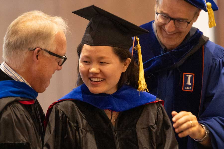 doctoral graduate receiving congratulations