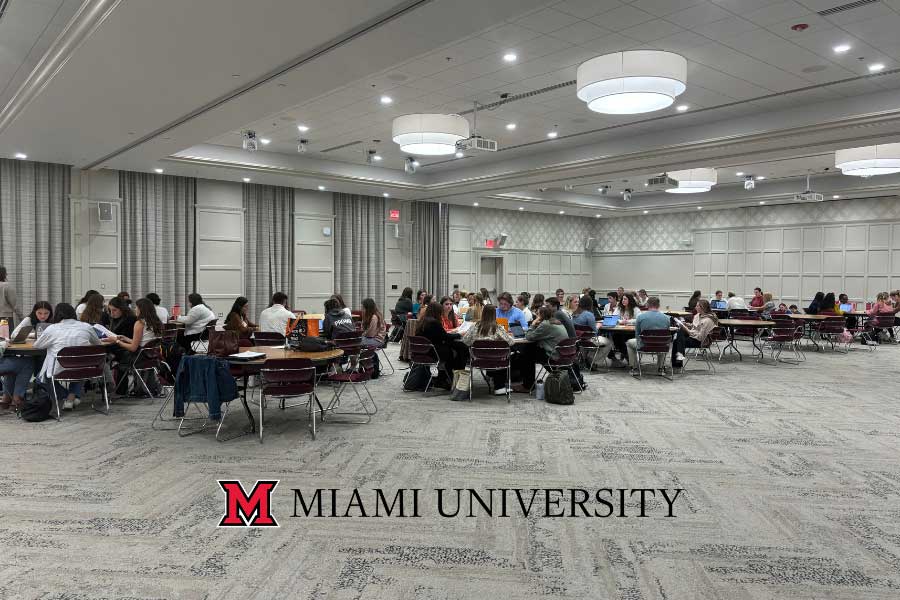 Students gathered in the Dolibois Room in the Shriver Center around several round tables at the mock Evaluation Team Report meeting
