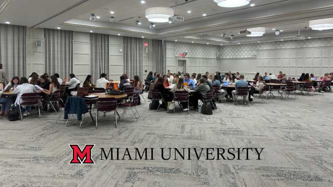 Students gathered in the Dolibois Room in the Shriver Center around several round tables at the mock Evaluation Team Report meeting