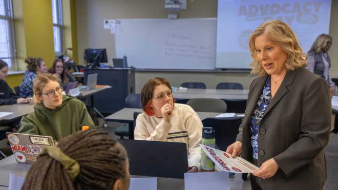 FSW professor Amy Roberts interacting with Social Work students during class.