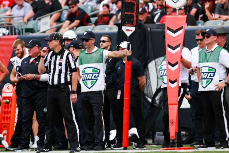 Sam Morris works the game-day sidelines as part of the chain crew.