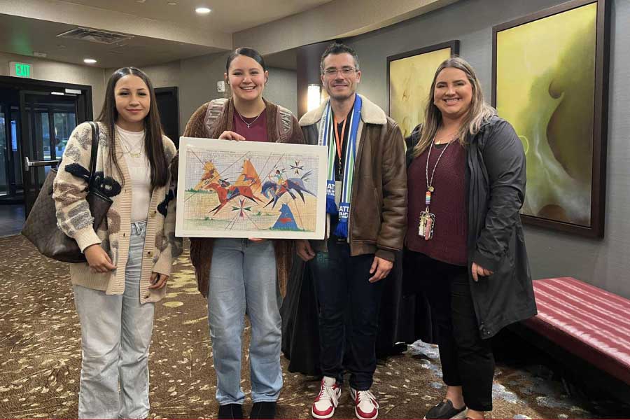 Sean Seiler presenting members of The Puyallup Tribe of Indians with artwork.