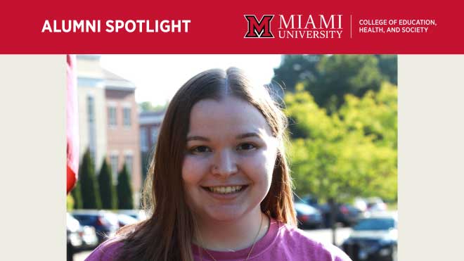 Leah Evans, a Miami University graduate, smiles while standing outdoors on campus with academic buildings and greenery behind her.