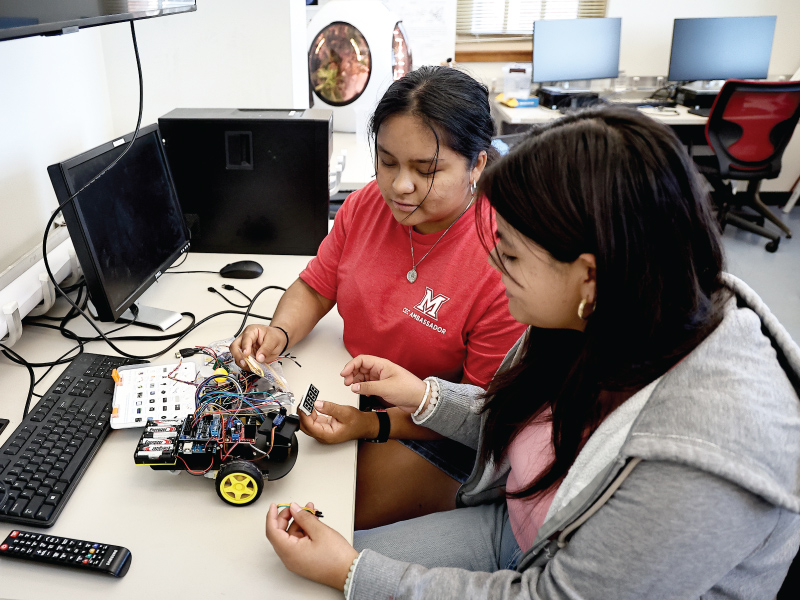 2 engineering students working on a electrical project.
