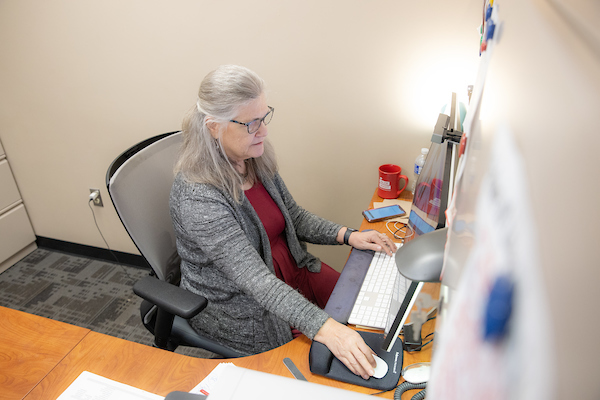 woman conducting research on computer