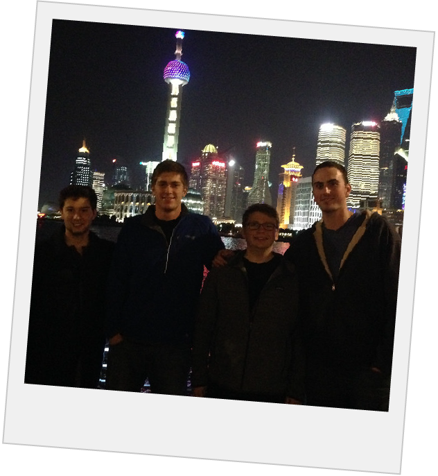 Polaroid of students in front of the shanghai skyline at night