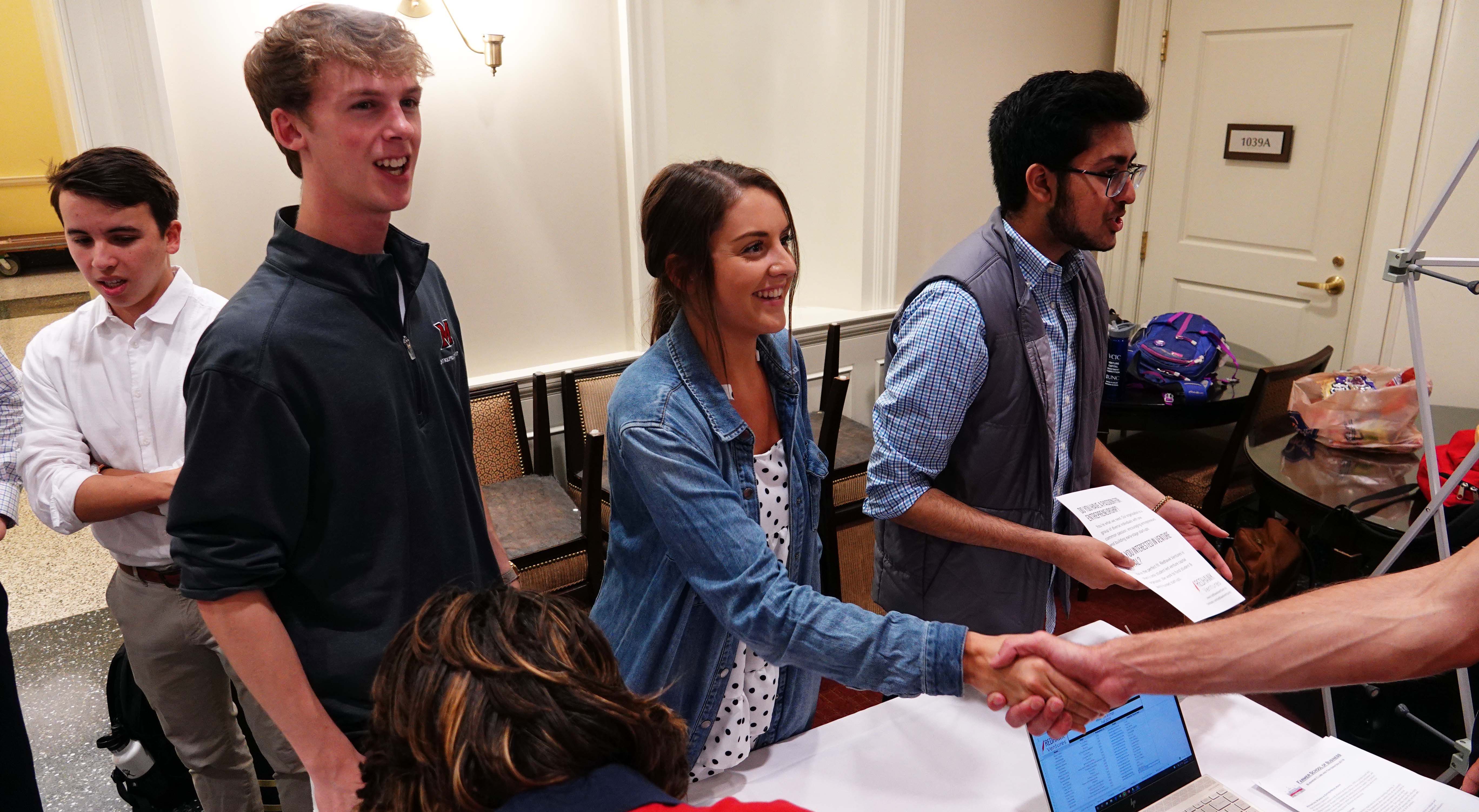 Andy Newman and Laura Mena meet students thinking about joining Redhawk Ventures