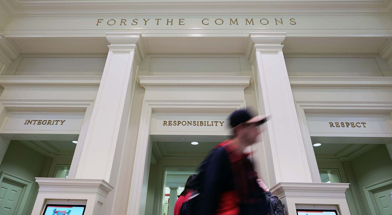 Image of the top of the Forsythe Commons with a student walking in front of the camera