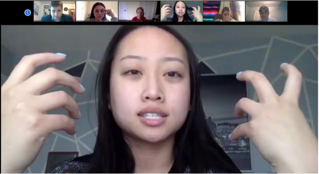A student makes her point and gestures to the screen during a Zoom meeting in class