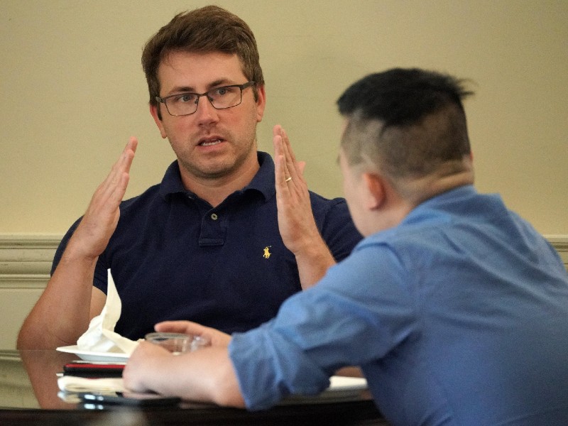 professor Jonathan Wolff sitting with student working on project