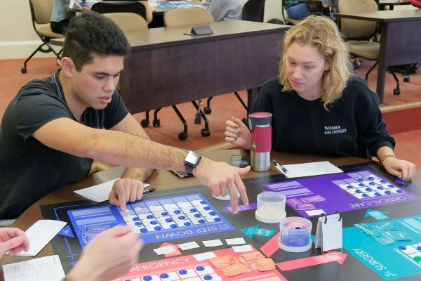 students working in accounting class with game