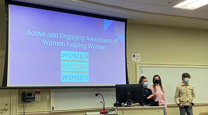 Women helping women presenting in a classroom