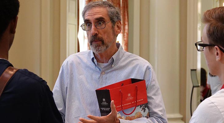 Photo of Dean Marc Rubin engaging in a conversation 